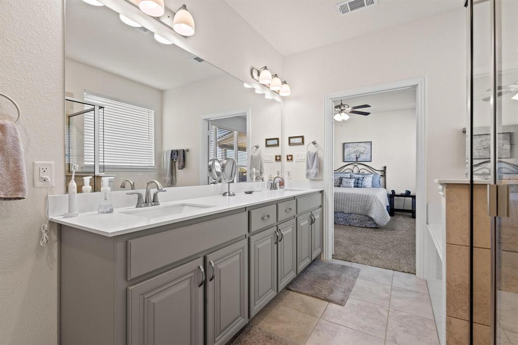 1875 Whitemound Road Sherman, TX 75090 - Photo 23 of 40 a spacious bathroom with a double vanity sink a mirror and a bathtub