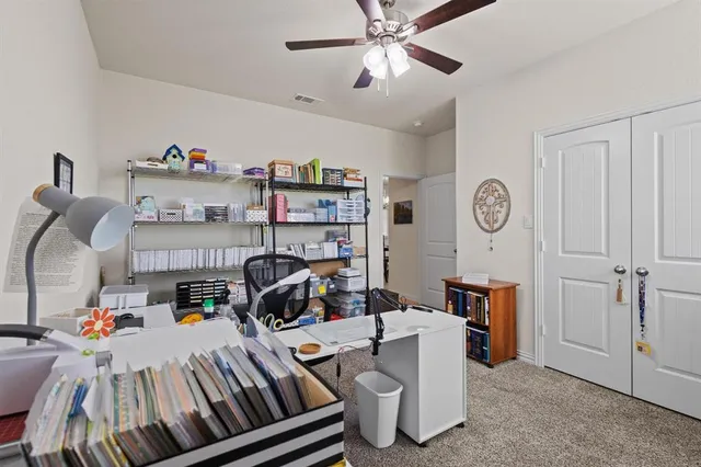 a bedroom with furniture and a chandelier fan
