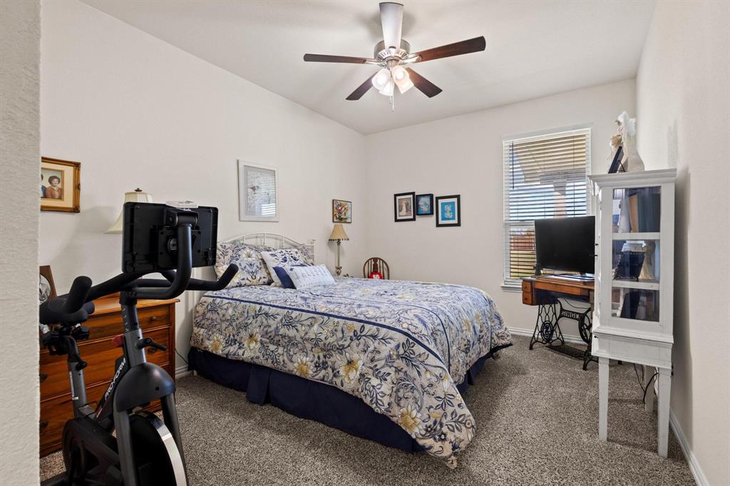 1875 Whitemound Road Sherman, TX 75090 - Photo 28 of 40 a bedroom with a bed and a flat screen tv