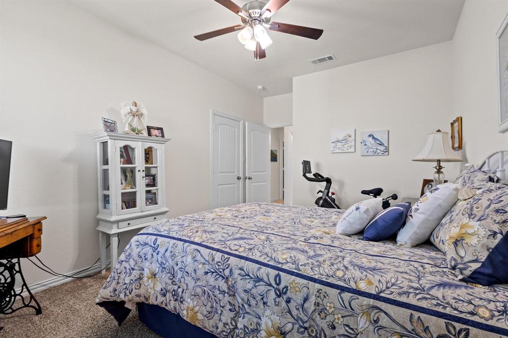 1875 Whitemound Road Sherman, TX 75090 - Photo 29 of 40 a bedroom with a bed and a chandelier