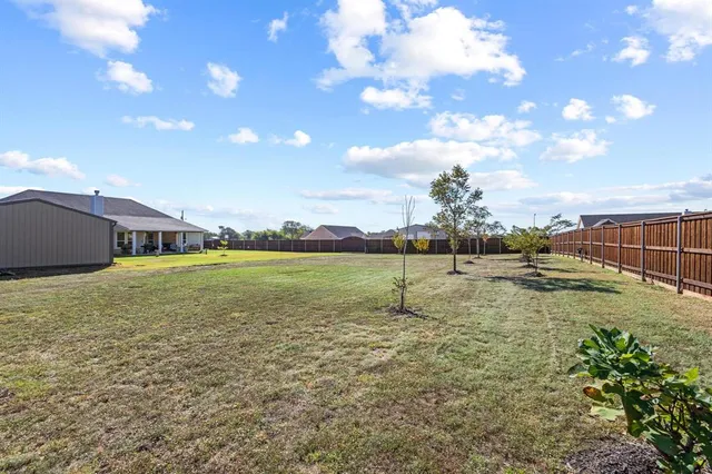 a swimming pool with yard and outdoor seating
