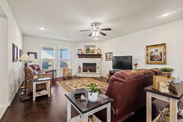 a living room with furniture fireplace and a flat screen tv