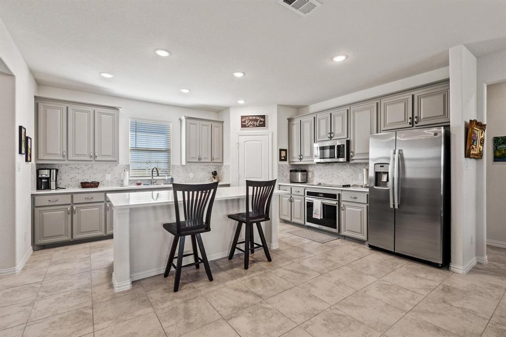 1875 Whitemound Road Sherman, TX 75090 - Photo 9 of 40 a kitchen with stainless steel appliances granite countertop a refrigerator and a stove top oven