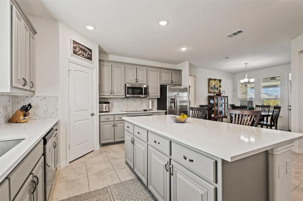 1875 Whitemound Road Sherman, TX 75090 - Photo 10 of 40 a kitchen with a sink a stove a refrigerator and white cabinets