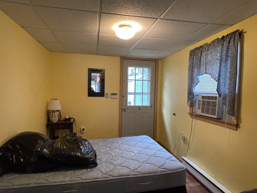 1634 Drift Road, Unit T Westport, MA 02790 - Photo 15 of 18 a bedroom with a bed and a window