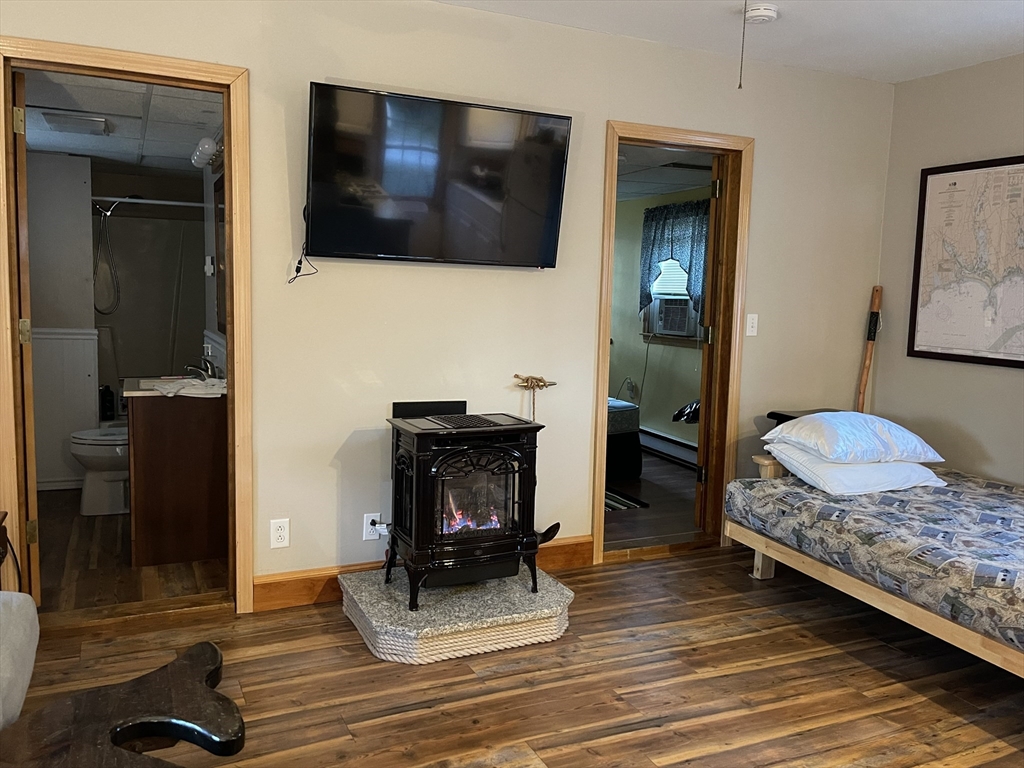 1634 Drift Road, Unit T Westport, MA 02790 - Photo 10 of 18 a bedroom with a bed and a flat screen tv