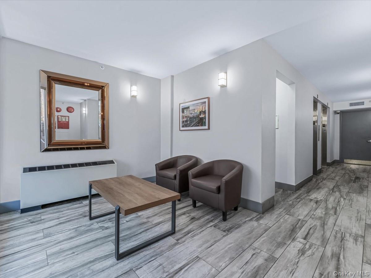 358 Grove Street, Unit 2E Brooklyn, NY 11237 - Photo 11 of 15 a living room with furniture and a wooden floor