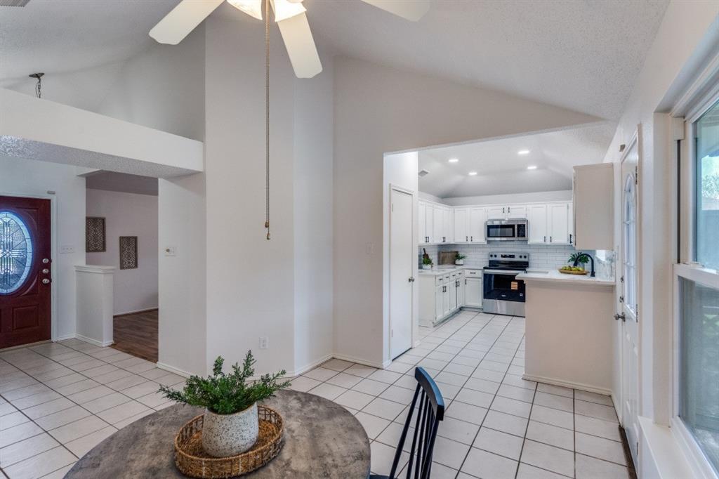 1509 Clover Drive Allen, TX 75002 - Photo 14 of 25 a open kitchen with white cabinets and stainless steel appliances