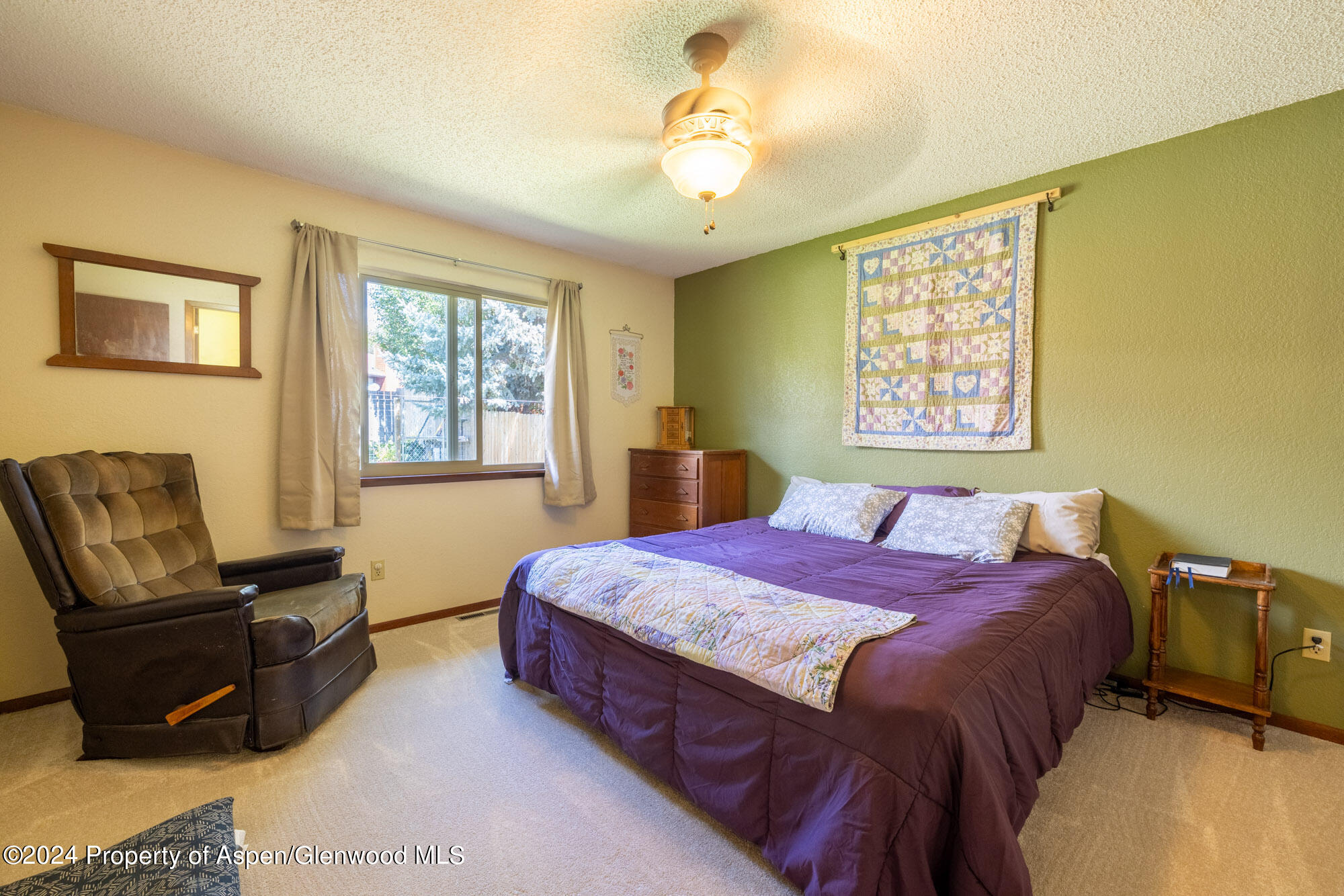 720 East 5th Street Rifle, CO 81650 - Photo 13 of 27 a bedroom with a bed and wooden floor