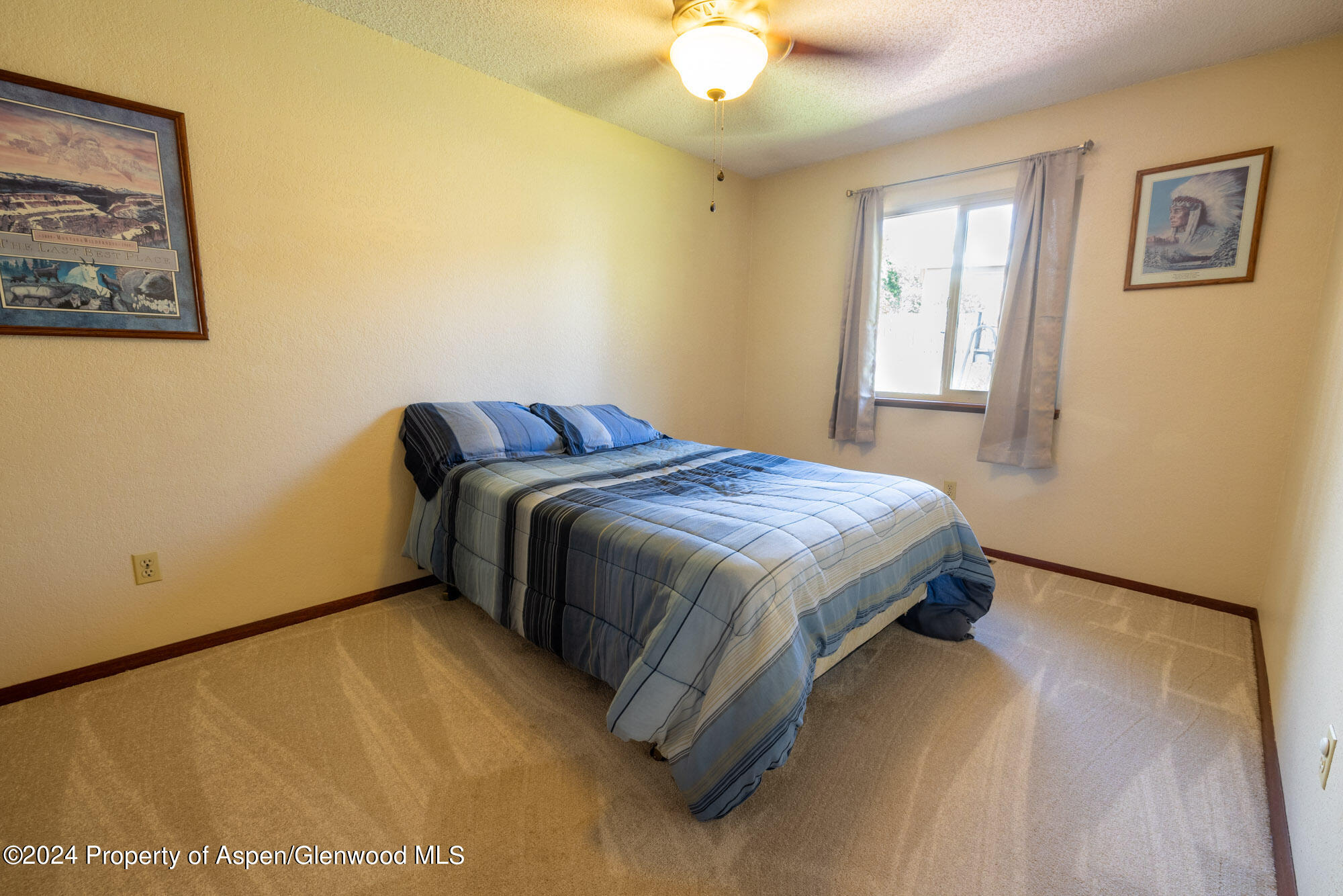 720 East 5th Street Rifle, CO 81650 - Photo 14 of 27 a bedroom with a bed and a window