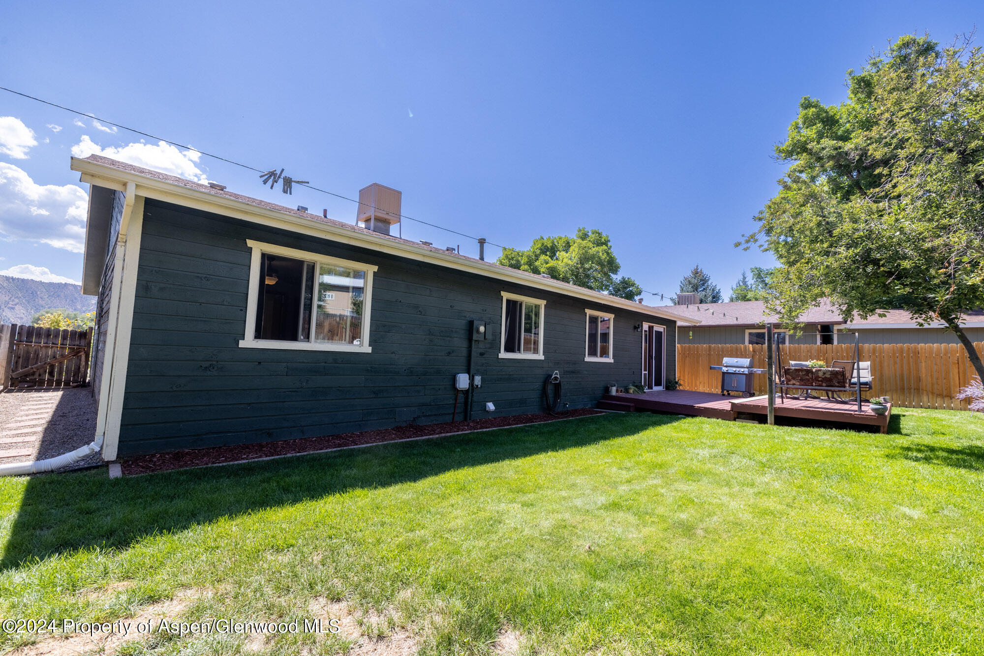 720 East 5th Street Rifle, CO 81650 - Photo 18 of 27 a view of a house with a yard and sitting area