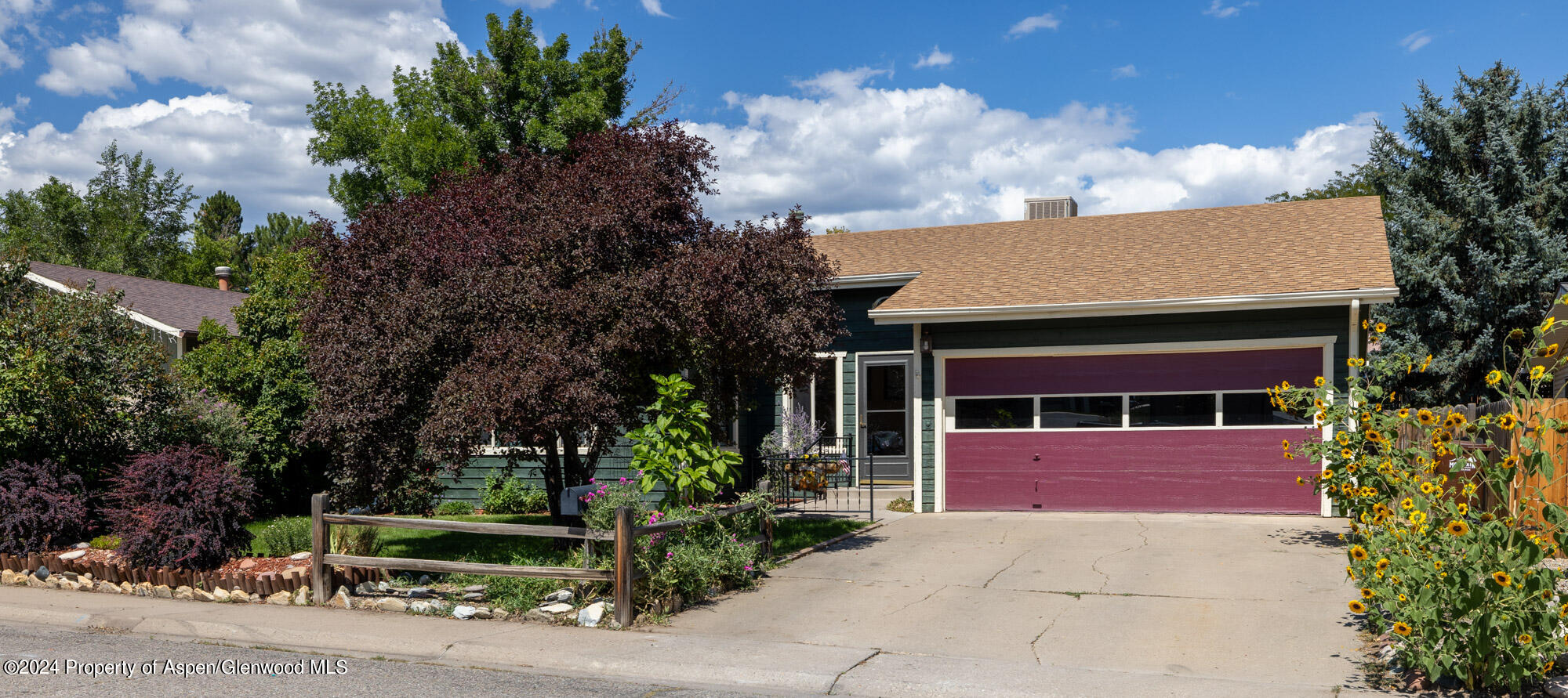 720 East 5th Street Rifle, CO 81650 - Photo 3 of 27 a front view of a house with a garden