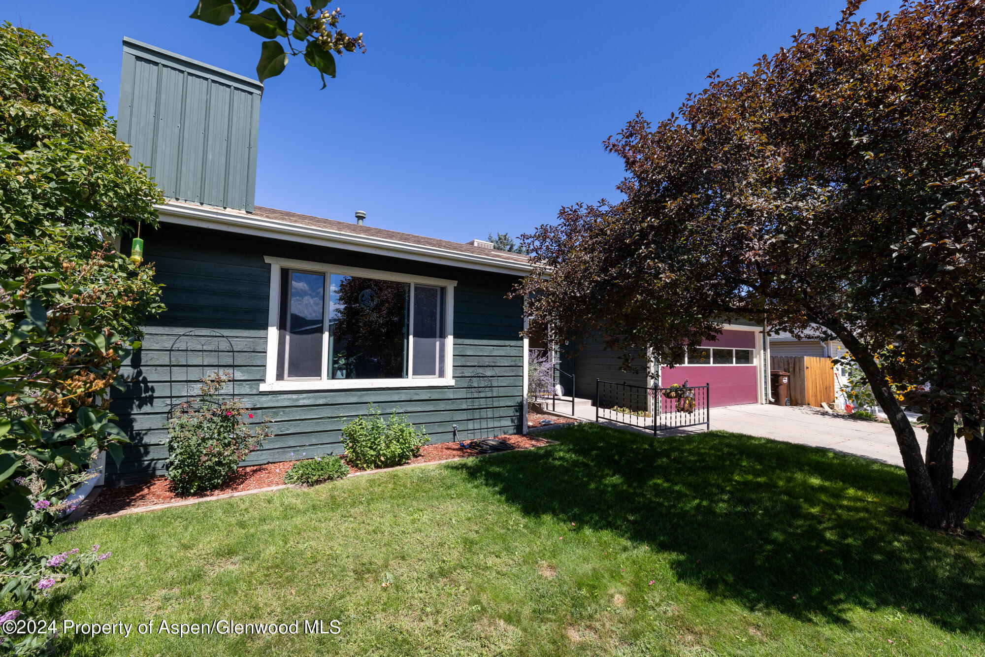 720 East 5th Street Rifle, CO 81650 - Photo 4 of 27 a house view with a garden space