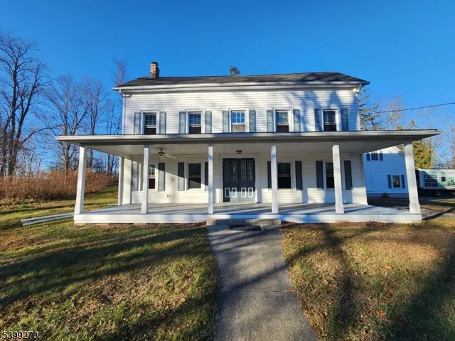 a front view of a house with a yard table and chairs