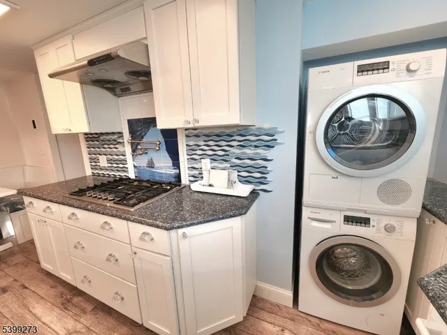 a kitchen with sink stove and refrigerator