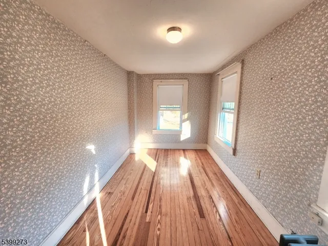 a view of a room with wooden floor