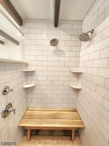 a bathroom with a double vanity sink a mirror and a bathtub