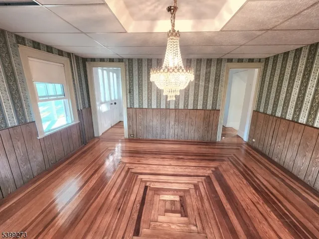 a view of empty room with wooden floor and fireplace