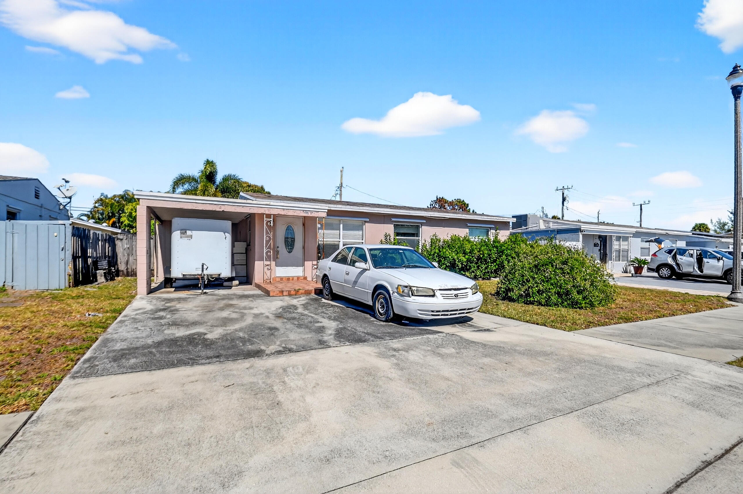 2013 Longwood Road West Palm Beach, FL 33409 - Photo 1 of 41 a view of a house with car parked