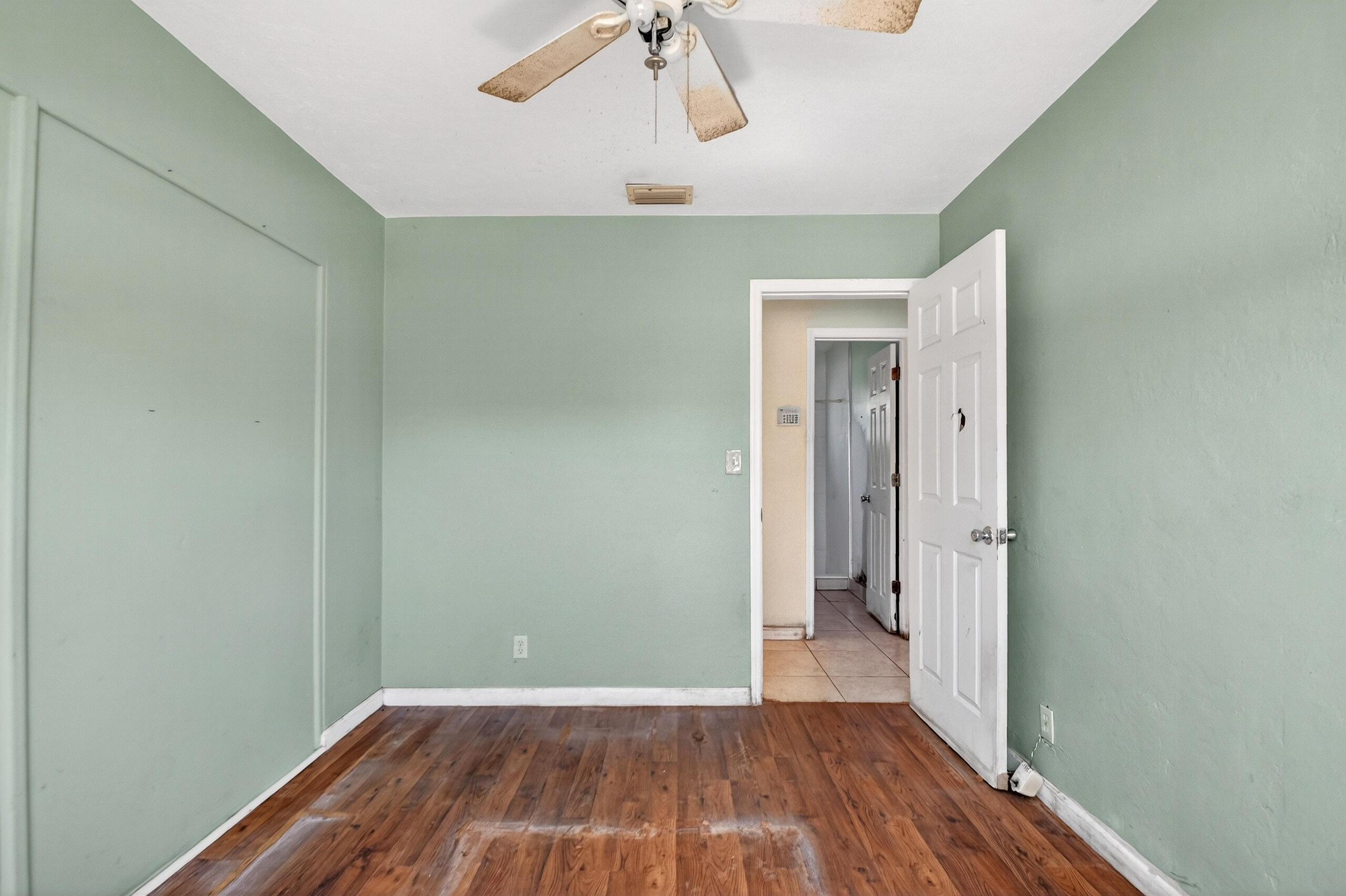 2013 Longwood Road West Palm Beach, FL 33409 - Photo 14 of 41 a view of a room with wooden floor staircase and a kitchen