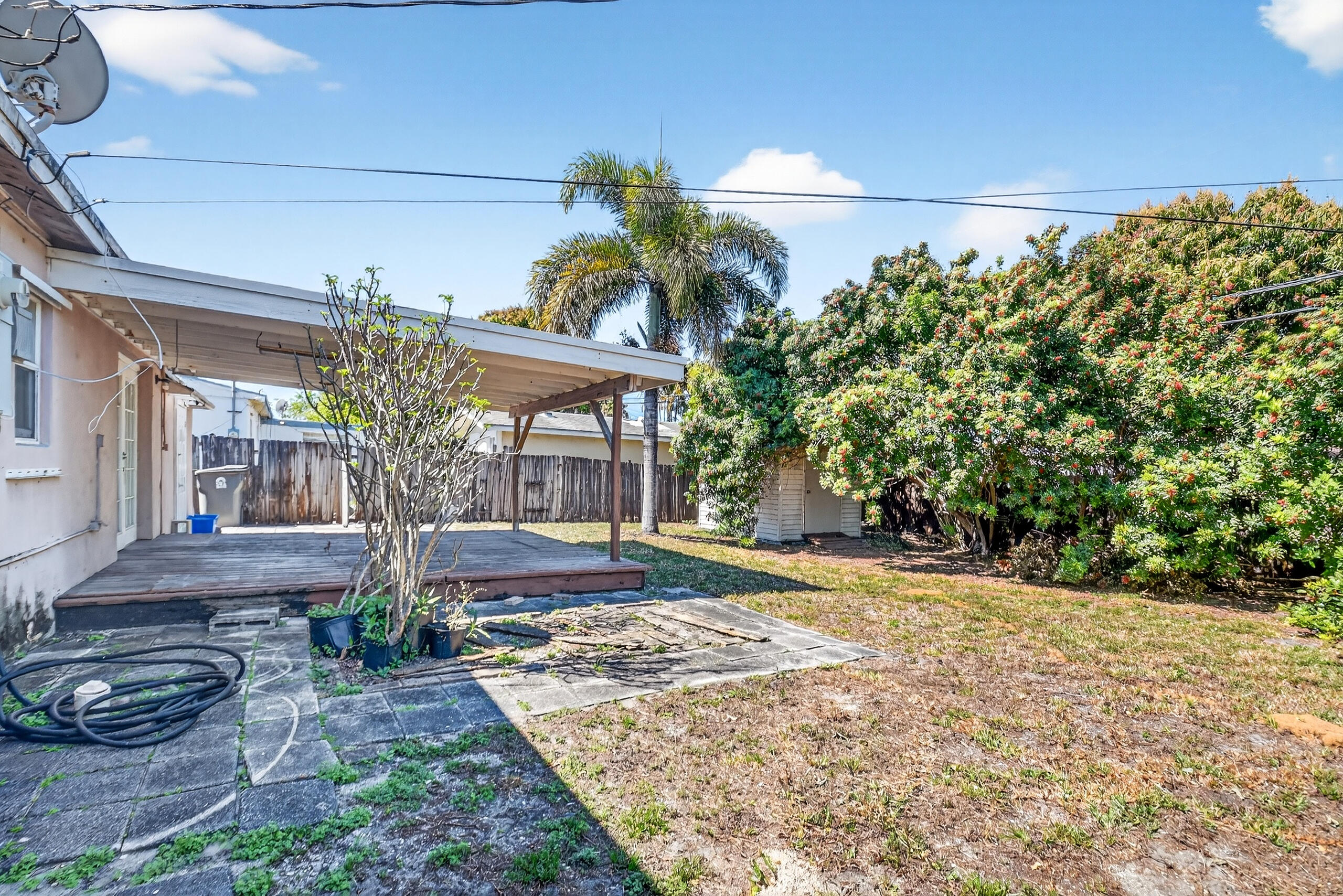 2013 Longwood Road West Palm Beach, FL 33409 - Photo 25 of 41 a view of a house with a small yard and potted plants