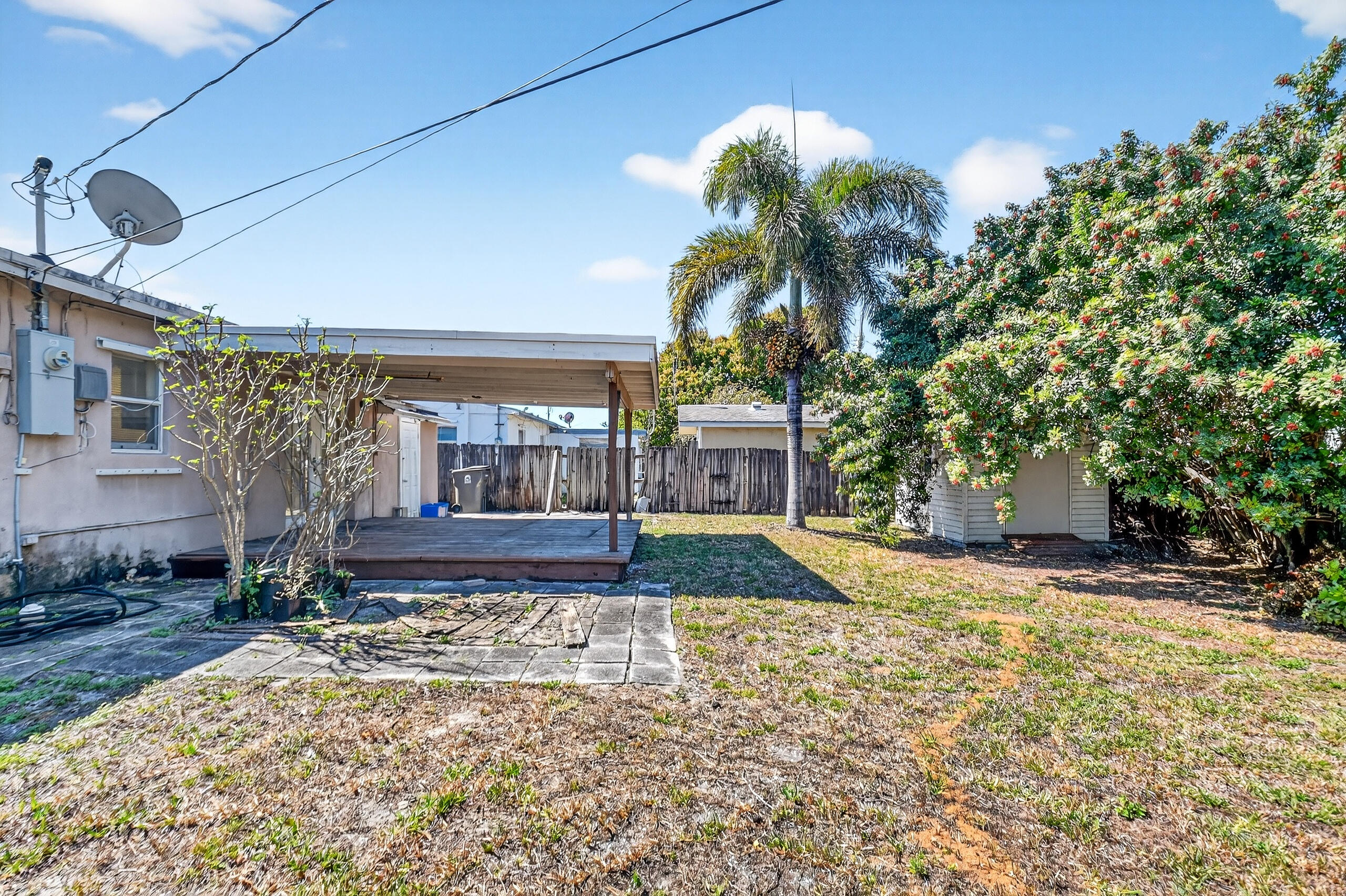 2013 Longwood Road West Palm Beach, FL 33409 - Photo 26 of 41 a view of a house with a yard and potted plants