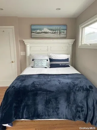 a bedroom with a bed and window