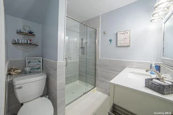 a bathroom with a toilet sink and shower