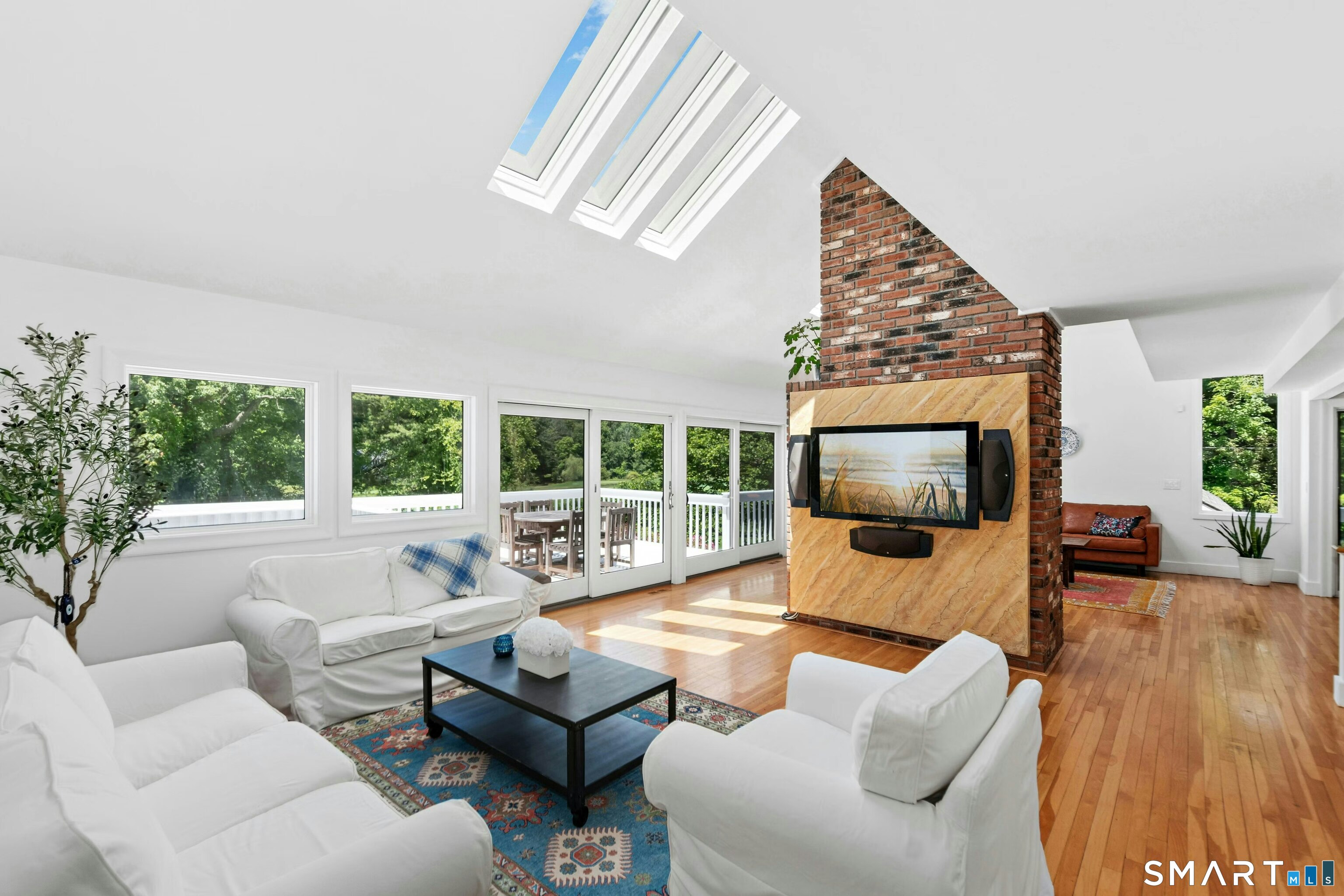 38 Old Redding Road Weston, CT 06883 - Photo 8 of 40 The Living Room opens to a Great Room which is bursting with sunlight, and also has the high vaulted ceilings and skylights.