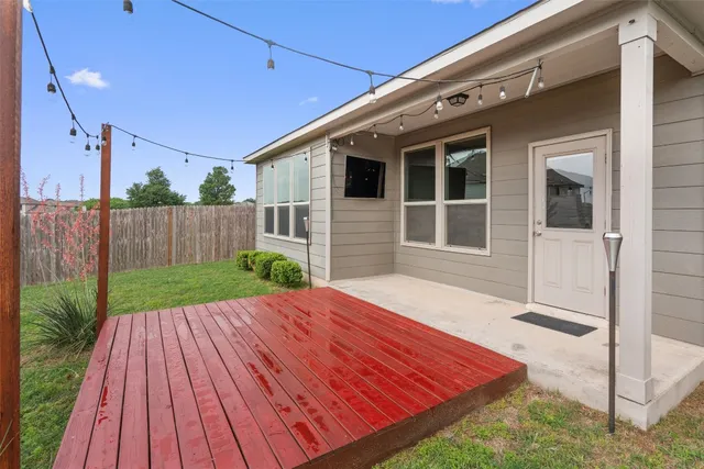 a view of house with backyard and wooden floor