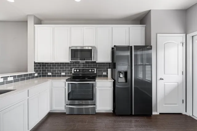 a kitchen with a refrigerator stove and sink
