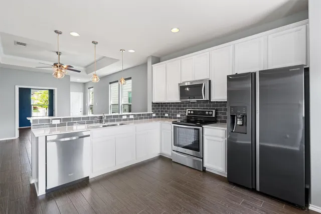 a kitchen with a refrigerator and a sink