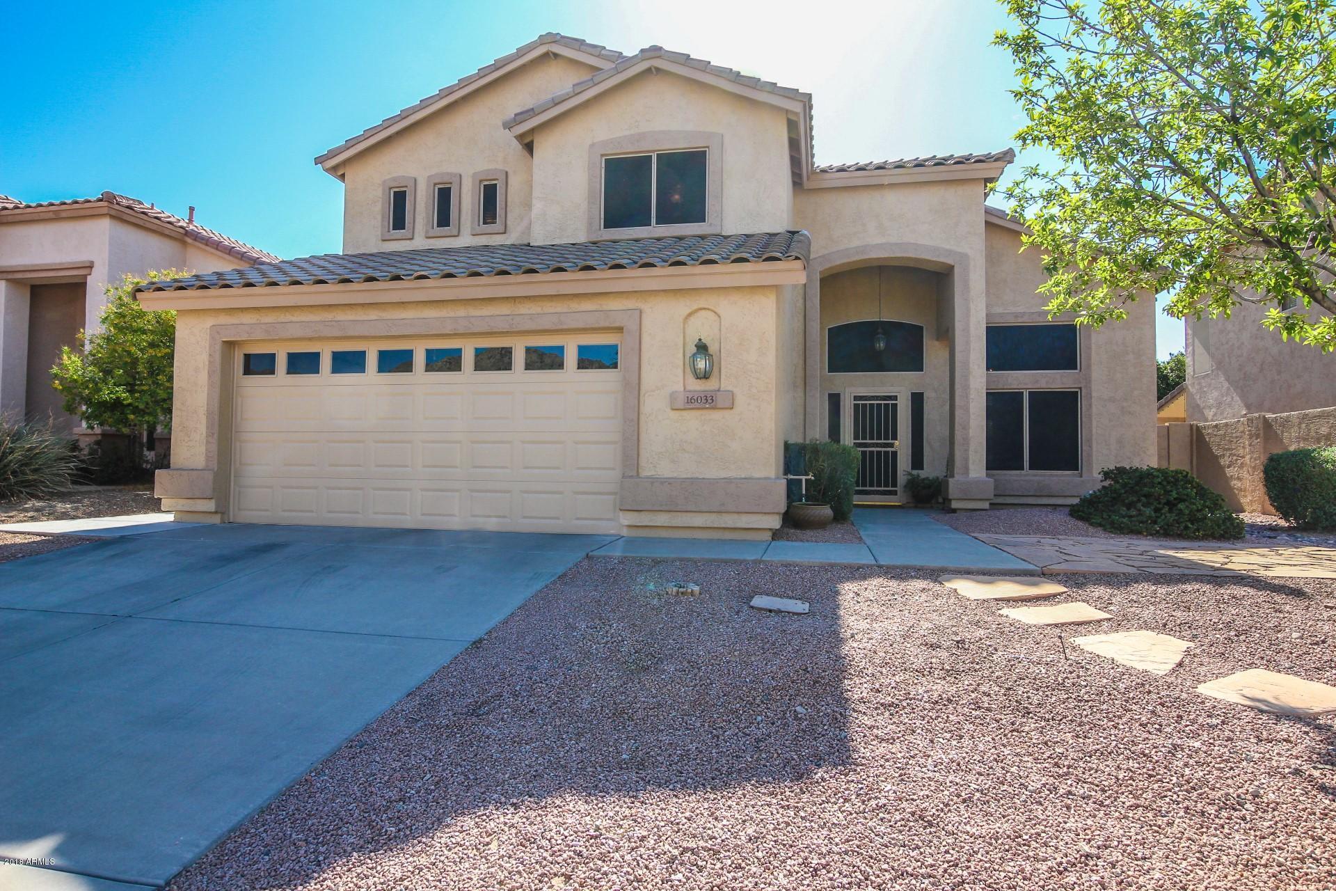 16033 South 18th Drive Phoenix, AZ 85045 - Photo 1 of 30 a front view of a house with a yard and garage