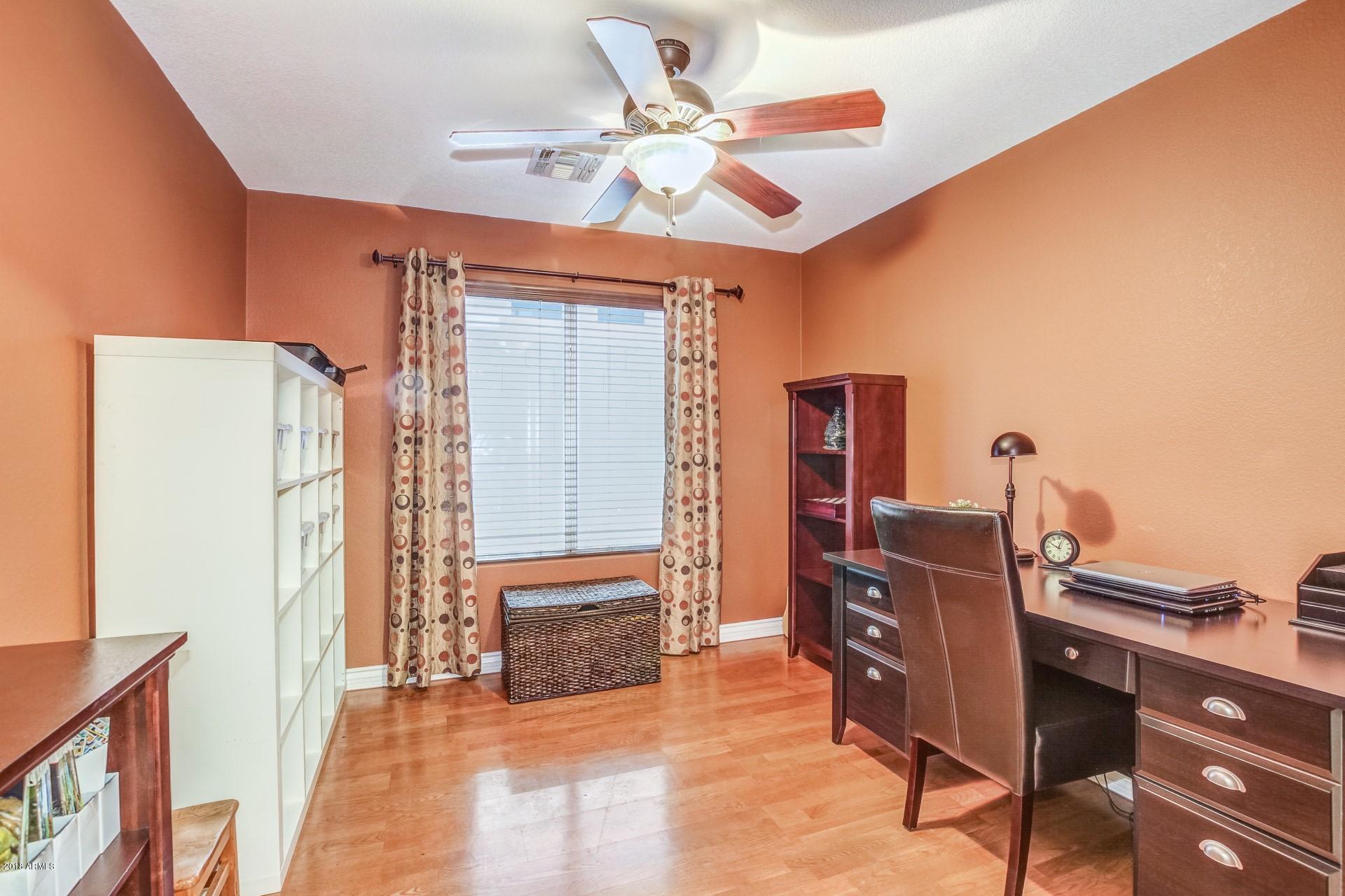 16033 South 18th Drive Phoenix, AZ 85045 - Photo 12 of 30 a view of workspace with wooden floor and ceiling fan