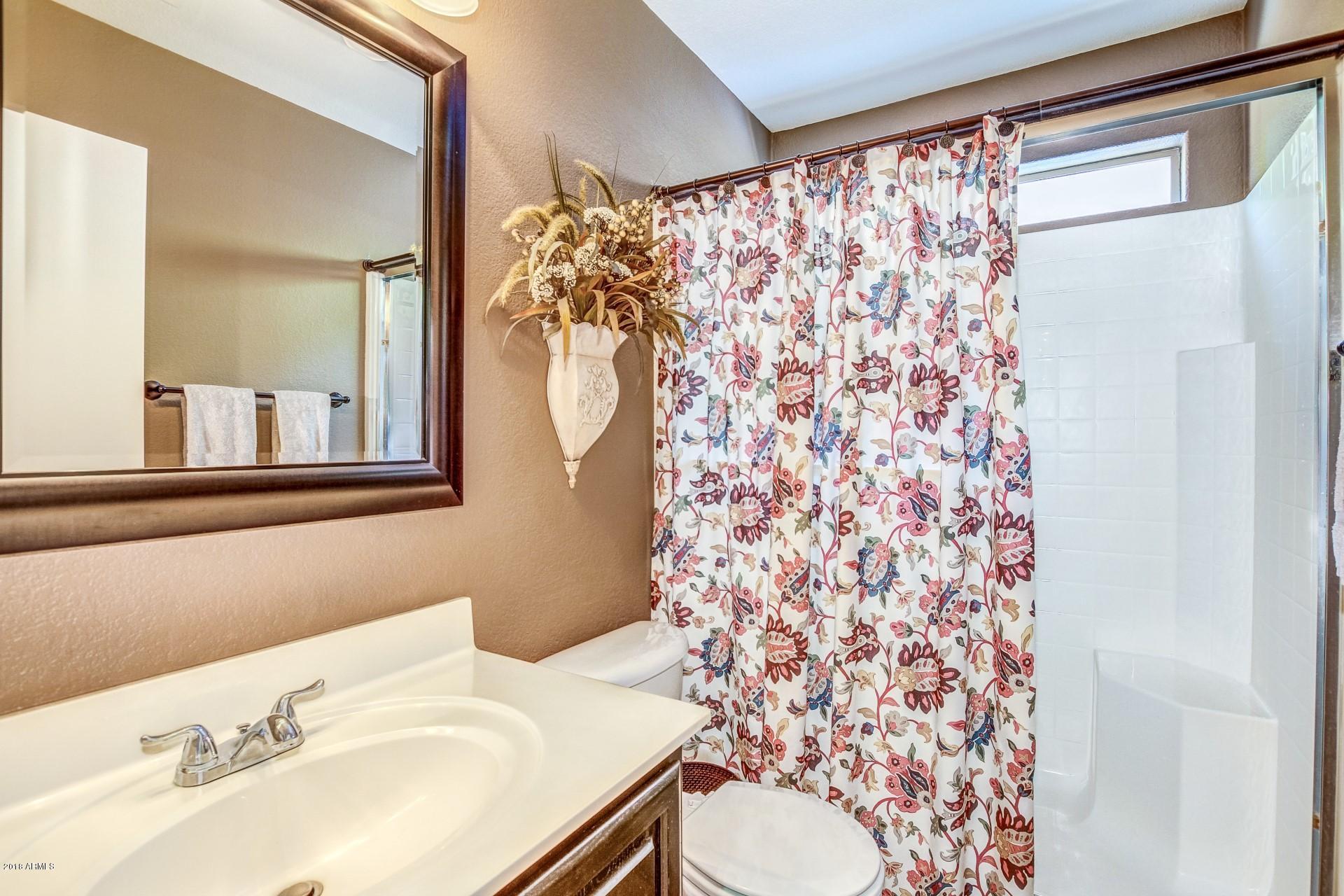 16033 South 18th Drive Phoenix, AZ 85045 - Photo 13 of 30 a bathroom with a sink toilet and shower