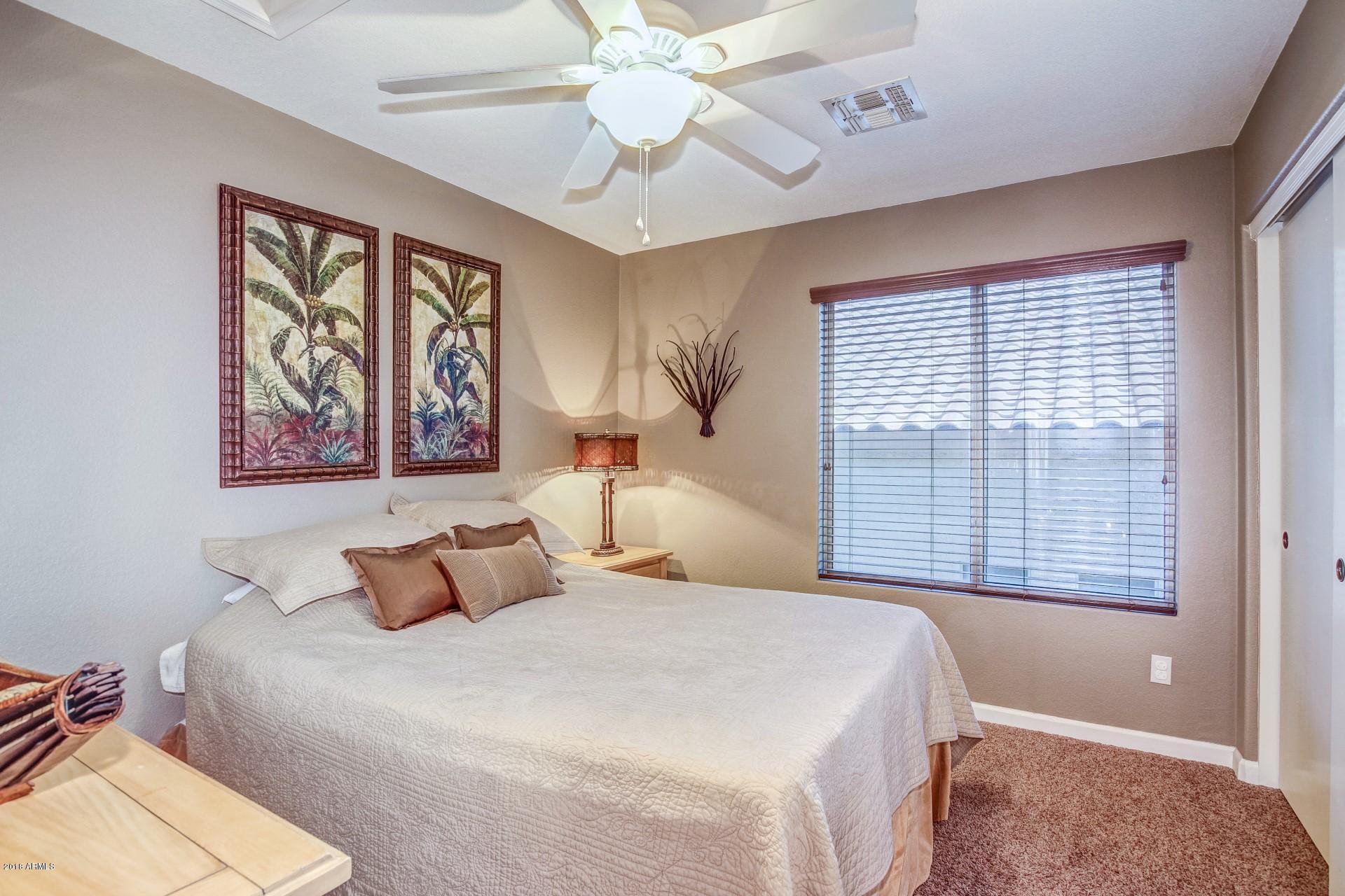 16033 South 18th Drive Phoenix, AZ 85045 - Photo 19 of 30 a bedroom with a large bed and a window