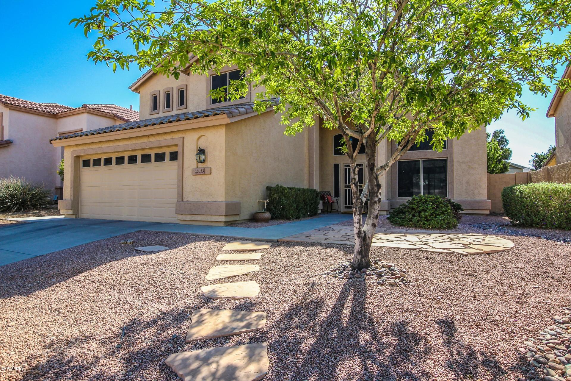 16033 South 18th Drive Phoenix, AZ 85045 - Photo 2 of 30 a front view of a house with garden