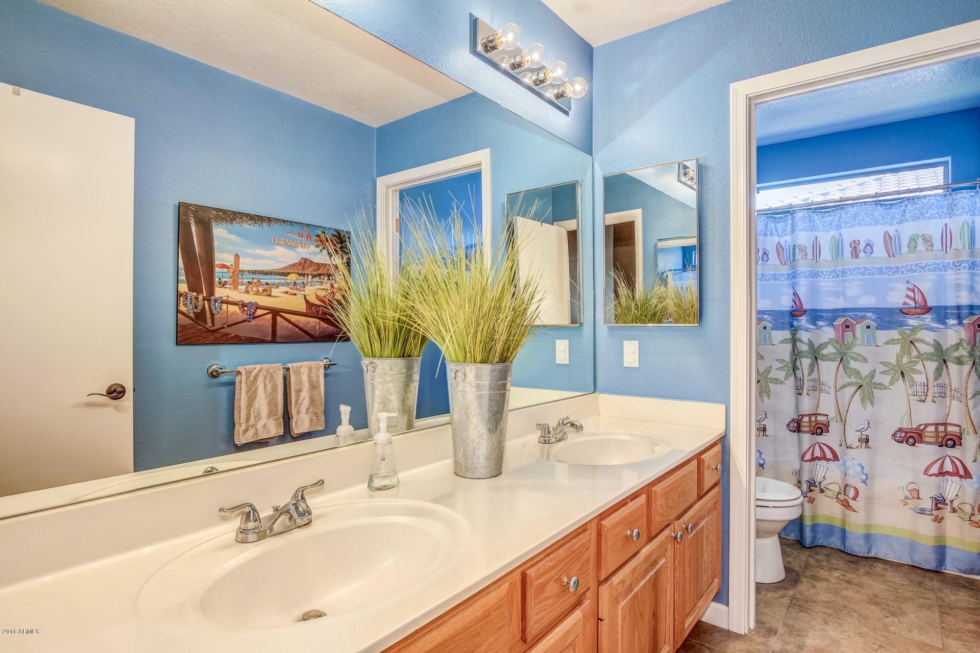 16033 South 18th Drive Phoenix, AZ 85045 - Photo 23 of 30 a bathroom with a double vanity sink and a mirror
