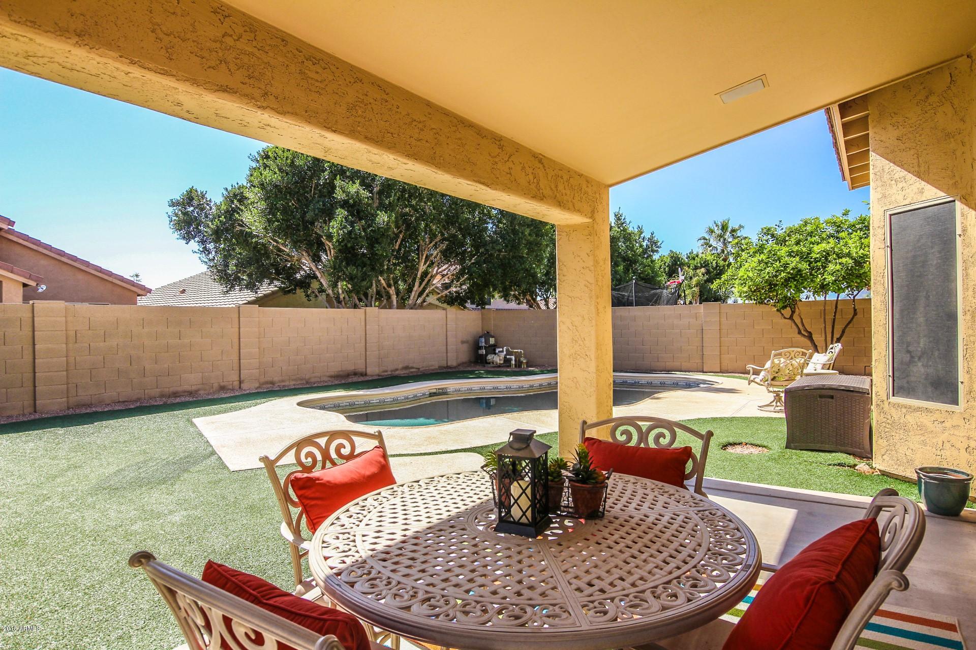 16033 South 18th Drive Phoenix, AZ 85045 - Photo 24 of 30 a outdoor sitting area with furniture and a garden