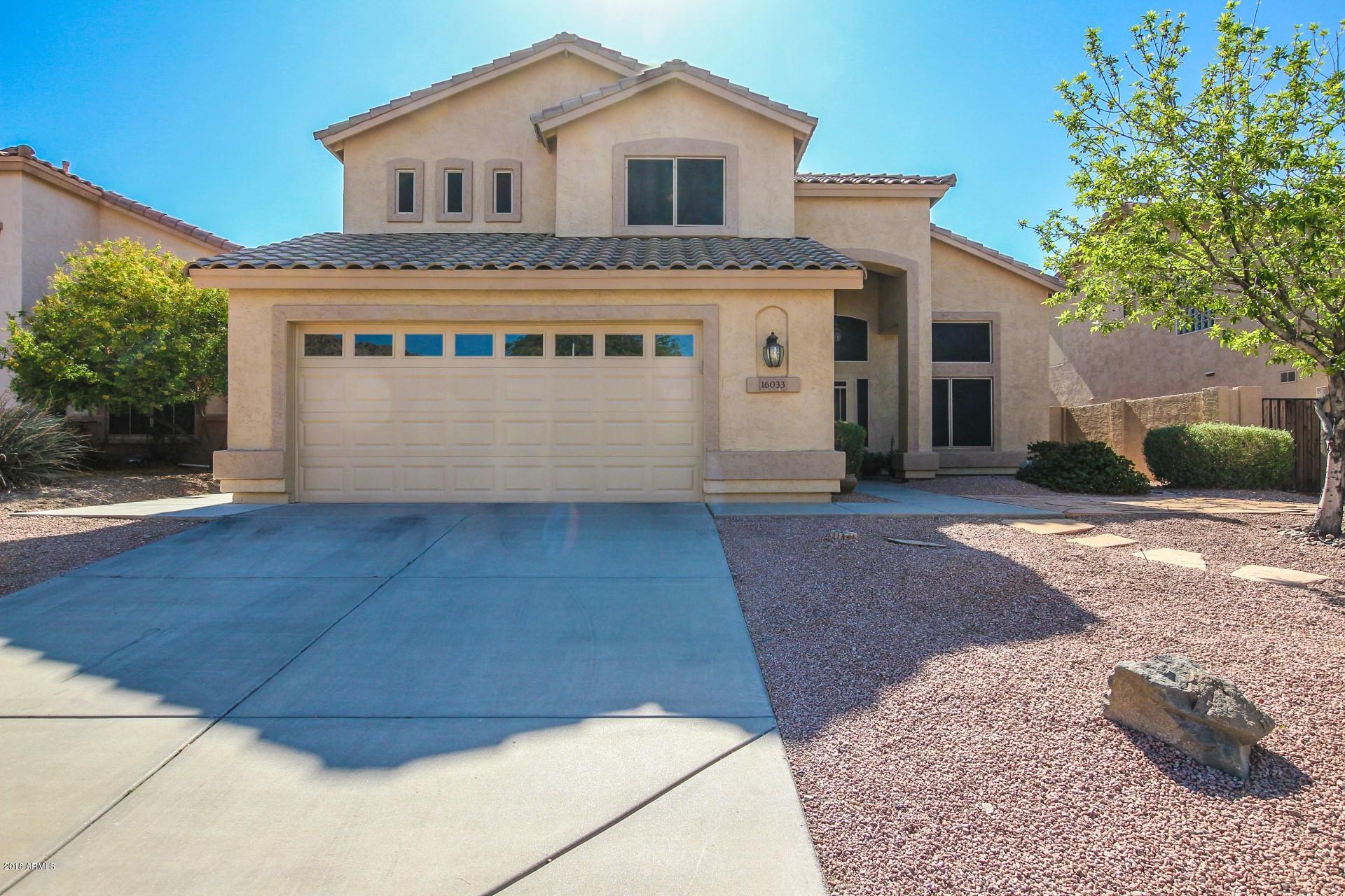 16033 South 18th Drive Phoenix, AZ 85045 - Photo 29 of 30 a front view of a house with a yard and garage