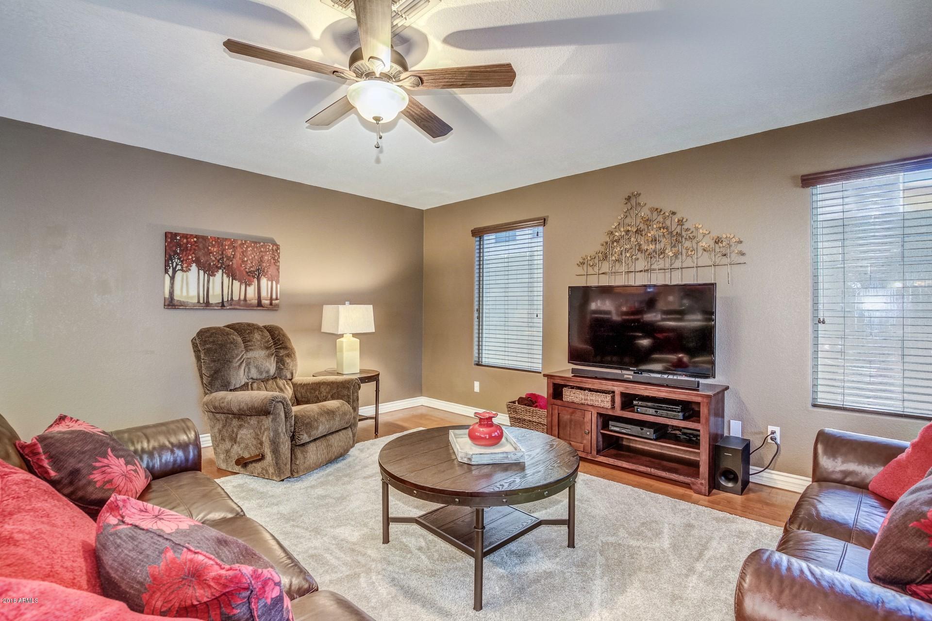 16033 South 18th Drive Phoenix, AZ 85045 - Photo 6 of 30 a living room with furniture and a flat screen tv