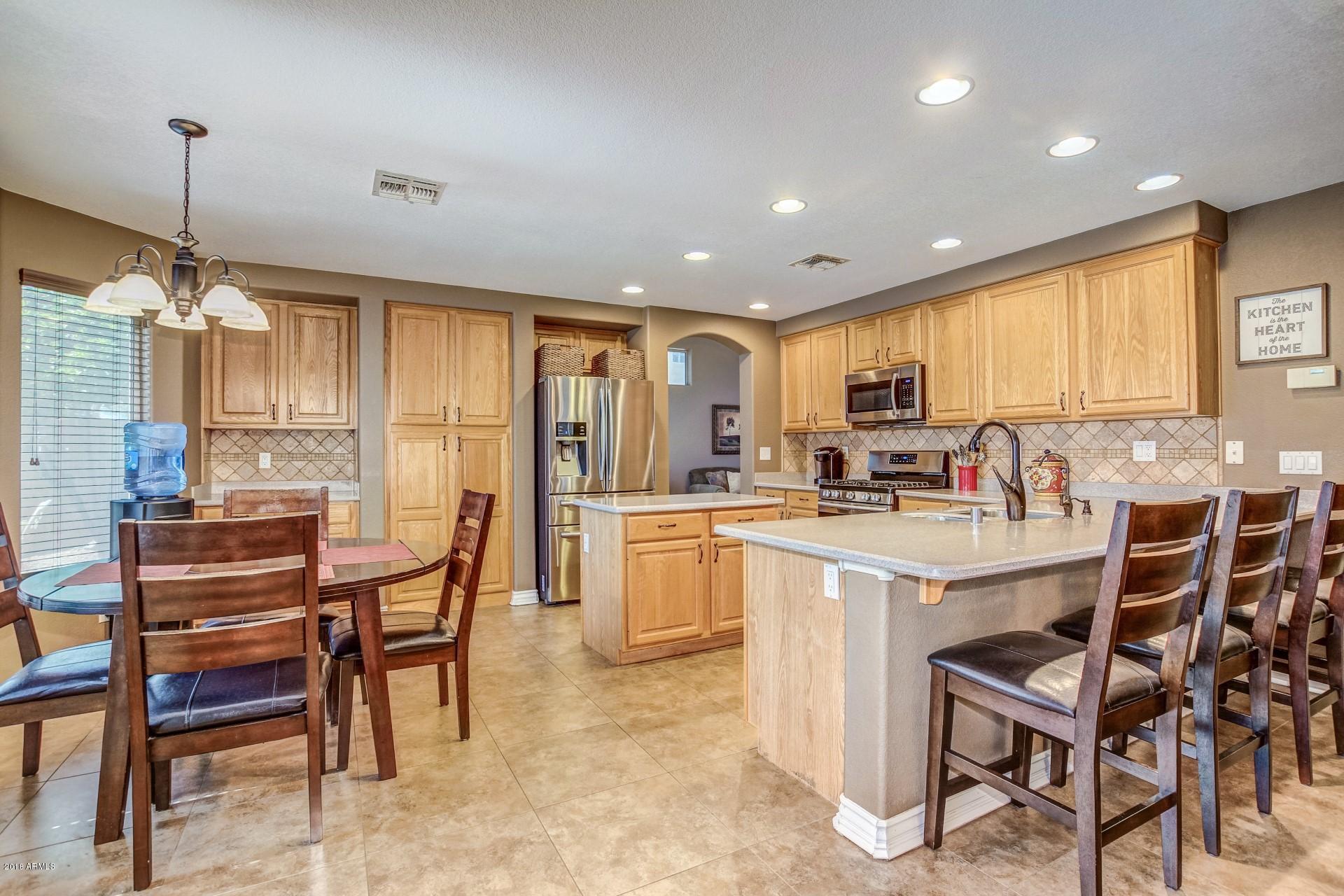 16033 South 18th Drive Phoenix, AZ 85045 - Photo 8 of 30 a kitchen with counter top space and appliances