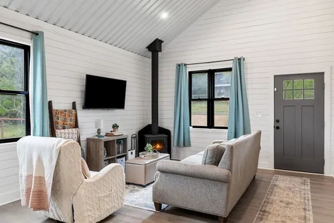 a living room with furniture and a flat screen tv