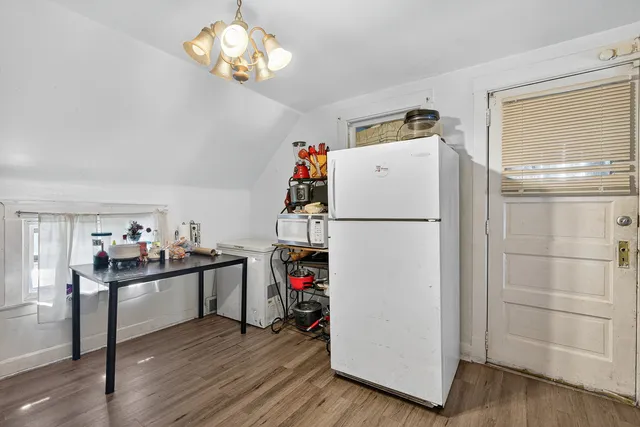 a kitchen with a refrigerator and a stove top oven