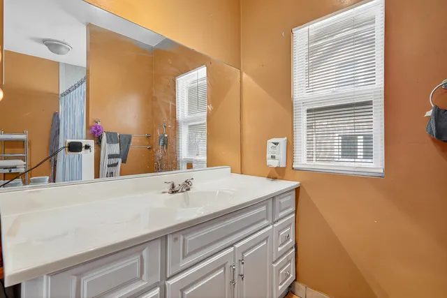 a bathroom with a sink and a mirror