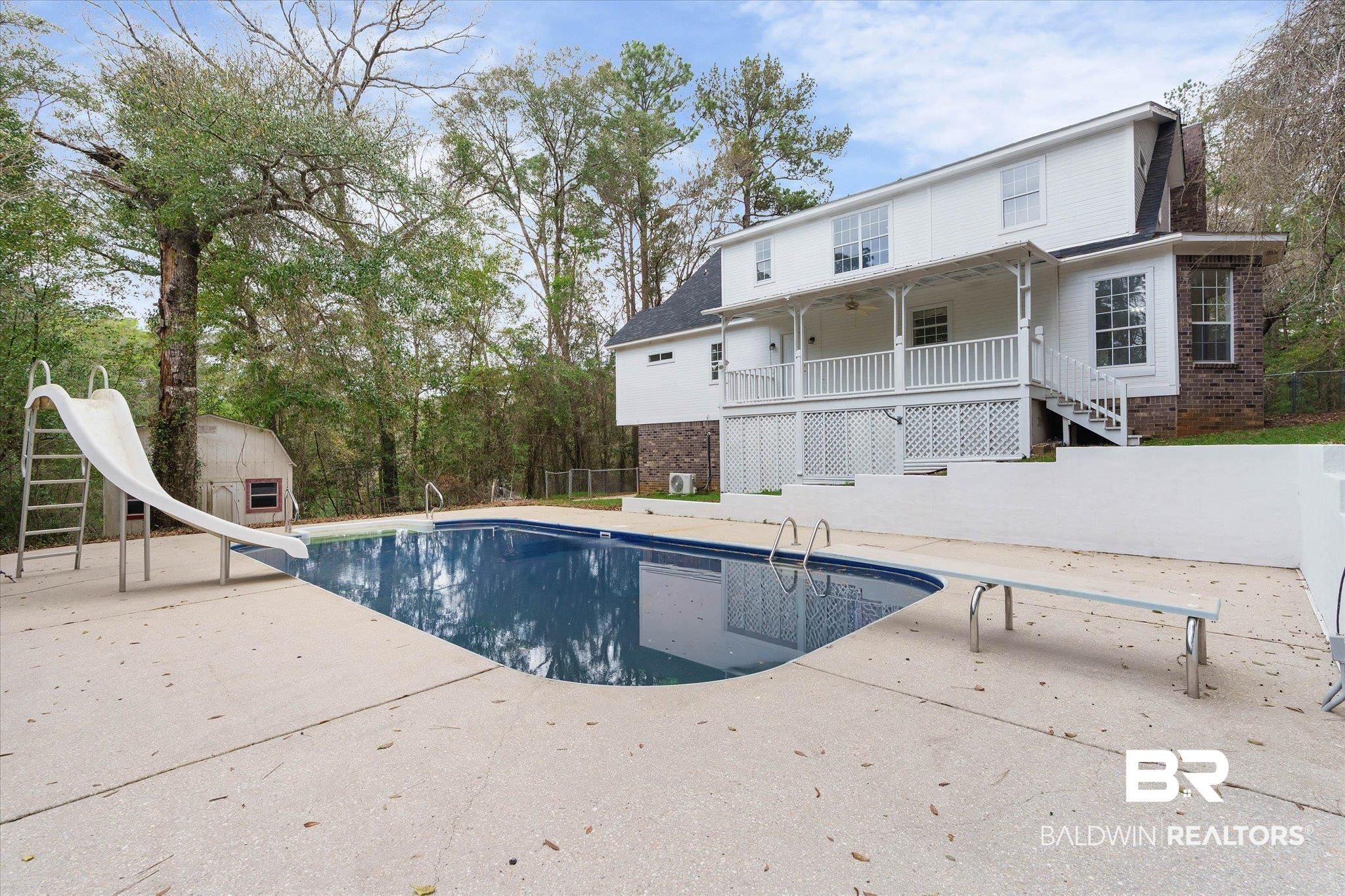 106 Melanie Loop Daphne, AL 36526 - Photo 38 of 45 View of swimming pool featuring a water slide, patio surround, a diving board, an outdoor structure, and view of scattered trees