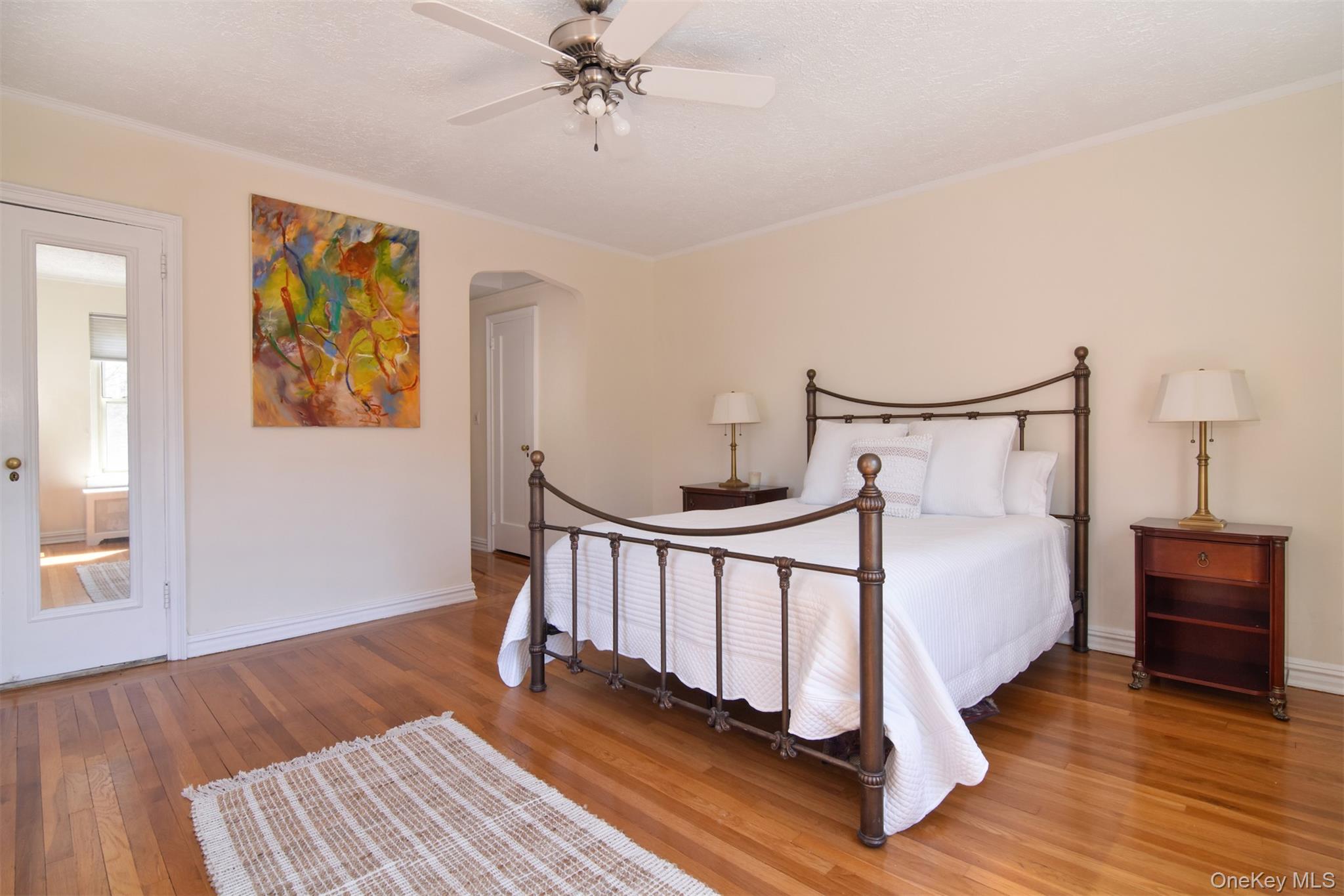 250 Bronxville Road, Unit 5A Bronxville, NY 10708 - Photo 12 of 20 a view of a bedroom with wooden floor and fan