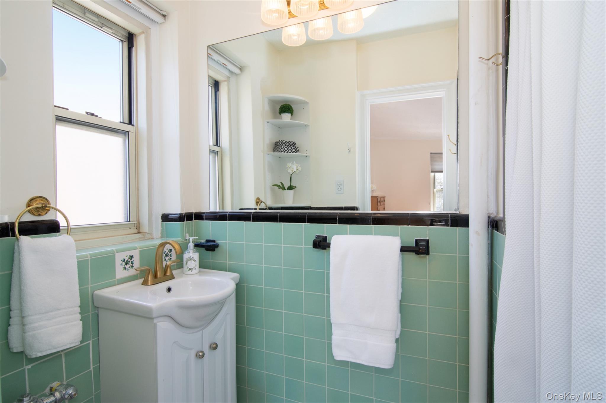 250 Bronxville Road, Unit 5A Bronxville, NY 10708 - Photo 15 of 20 a bathroom with a sink and a mirror