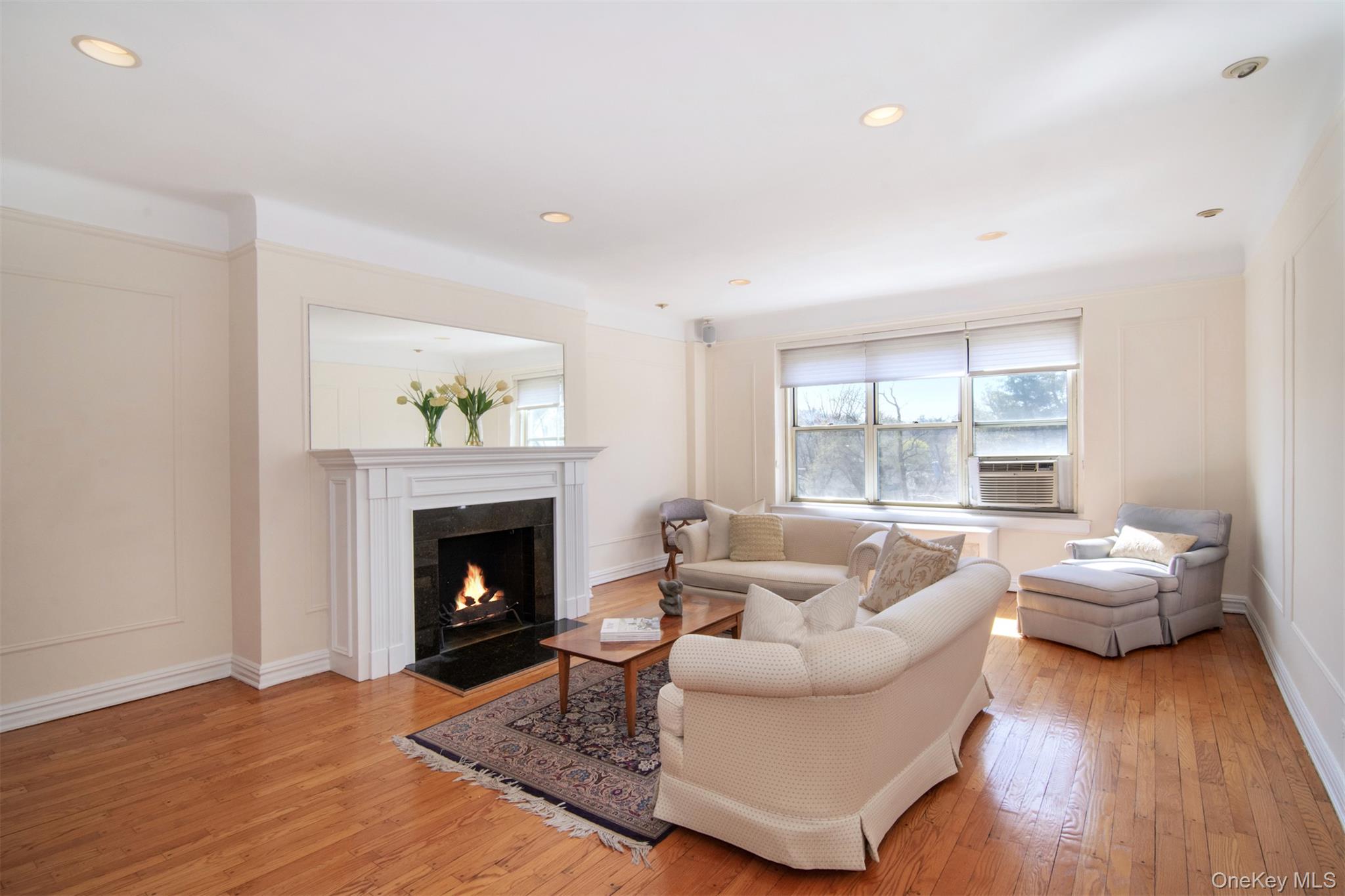 250 Bronxville Road, Unit 5A Bronxville, NY 10708 - Photo 2 of 20 a living room with furniture and a fireplace