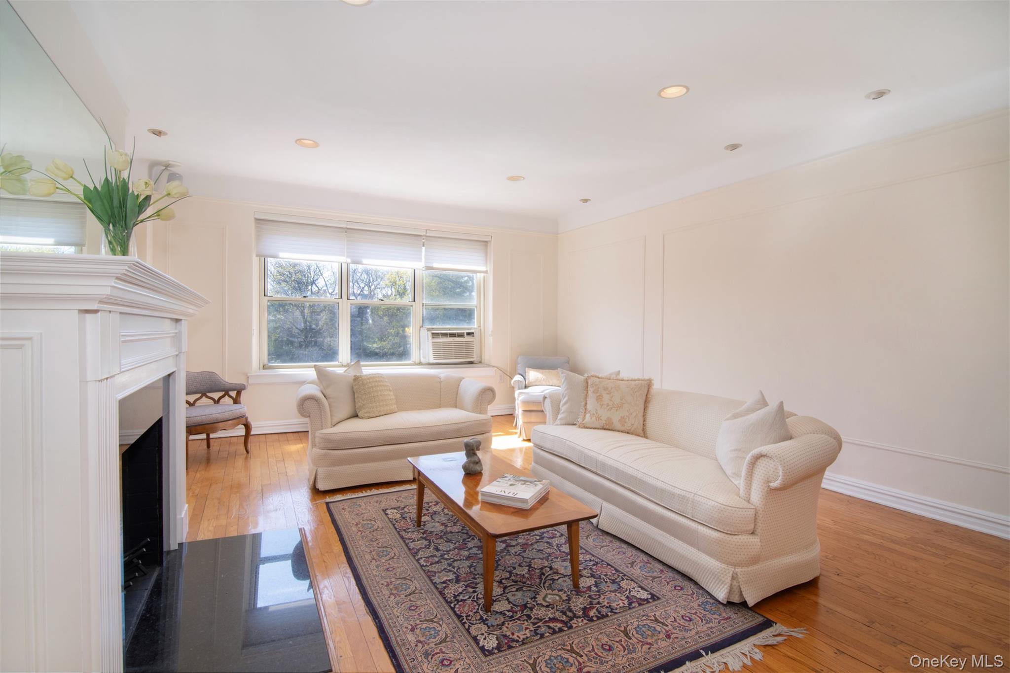 250 Bronxville Road, Unit 5A Bronxville, NY 10708 - Photo 3 of 20 a living room with furniture a fireplace and a large window